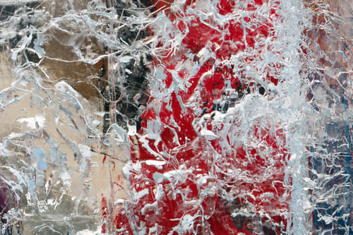 Preview: Glacial Transparent Wall Of Ice With Interesting Drawings And Patterns And Red Objects Behind.