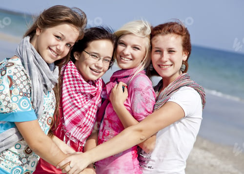 Preview: Four Hugging Girlfriends At The Beach.