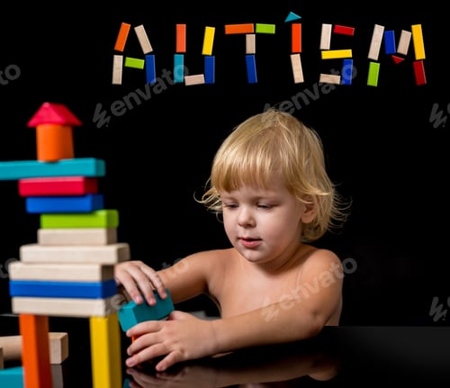 Preview: A Child With An Autism Spectrum Disorder Builds A House From A Wooden Constructor. Concept Of