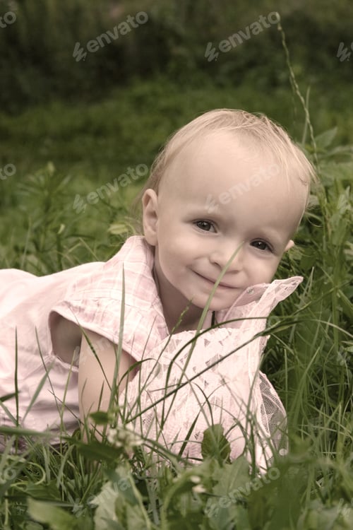 Preview: Portrait Of Little Girl On Green Grass
