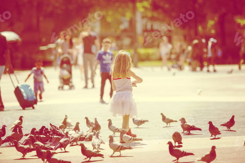 Preview: A Girl Feeding Pigeons In The Mall. Image Has A Strong Vintage Effect.