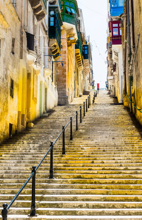 Preview: Typical Narrow Street With Stairs On The Island Of Malta. Buildings With Traditional Colorful