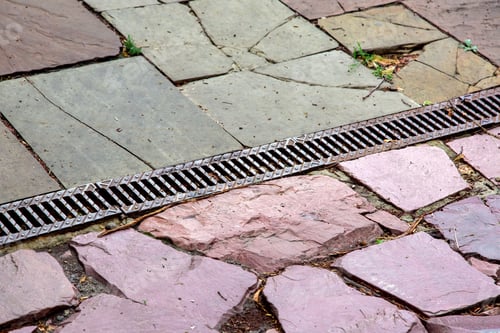 Preview: A Lattice Of A Drainage Paving System On A Walkway Made Of Cobblestone Tiles, Close Up Of A