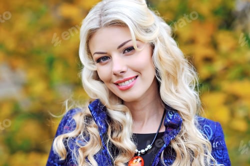 Preview: Portrait Of An Autumn Smiling Woman Over Leaves Background