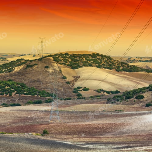 Preview: Olive Grove And Fields In Spain After Harvesting At Sunrise. Electrical Power Lines On Pylons In