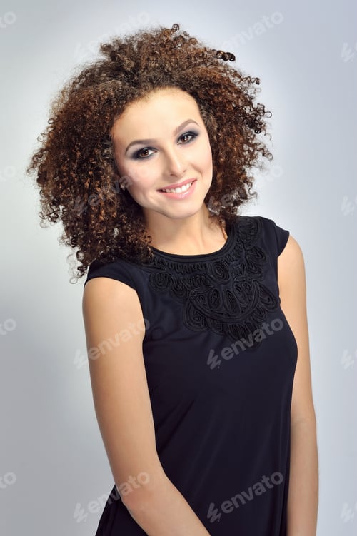 Preview: Portrait Of A Smiling Curly Haired European Woman