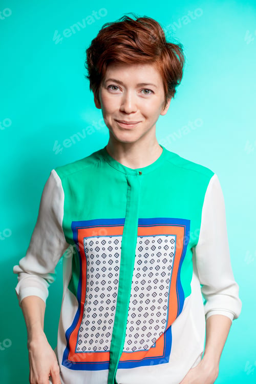 Preview: Stylish Young Slim Woman With Ginger Hair Feeling Confidence. Close Up Portrait.Isolated Blue