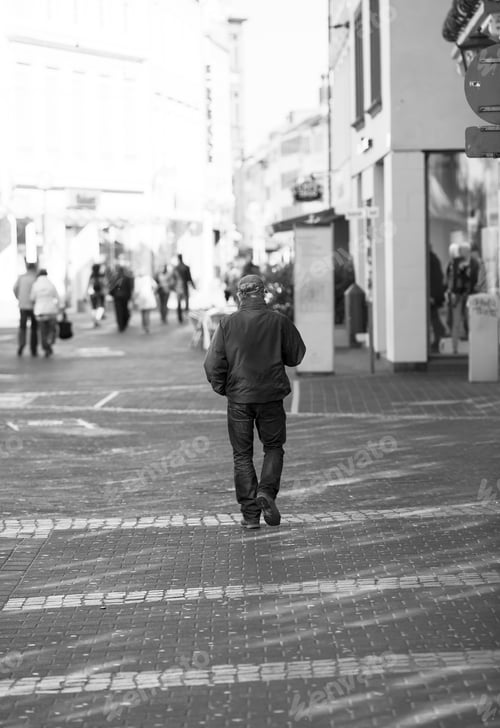 Preview: A Man Is Walking In The Streets. Image Taken From Behind. Image Has A Vintage Effect Applied.