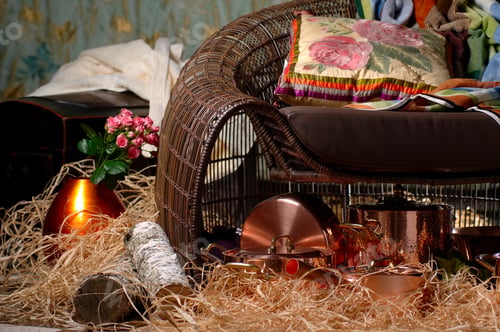 Preview: Wicker Chair With A Pillow And Bronze Metal Dishes On The Hay And Firewood Near