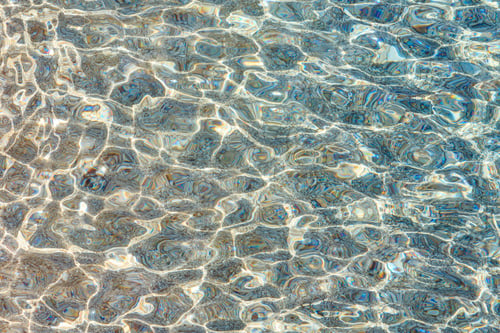 Preview: Blue Sea Flowing Water Surface With Waves And Some Pebbly Bottom View. Abstract Background Pattern.