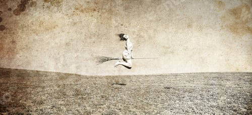 Preview: Young Red-Haired Witch On Broom Flying Over Grass Field. Photo In Old Image Style.