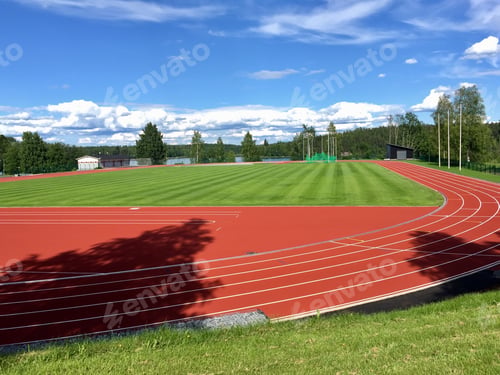 Preview: Sports Field On A Sunny Summer Day. Running Tracks And Green Football Field.
