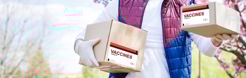 Preview: The Man Delivers The Vaccine. Placing Vaccine Label On The Cardboard Box