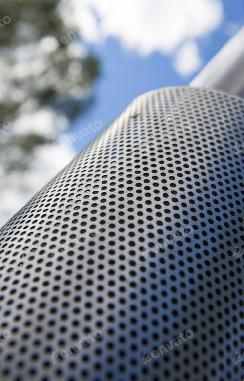 Preview: Metal Surface Textured Chimney. Image Taken From Low Point Of View With An Angle. Some Trees And