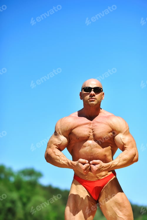 Preview: Bodybuilder Flexing His Muscles Outdoors