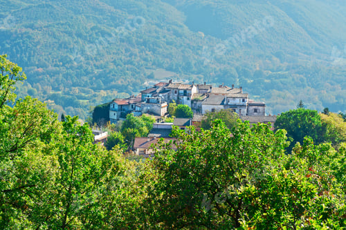 Preview: Medieval Italian City On A Hilltop Surrounded By Mountains Covered With Forests