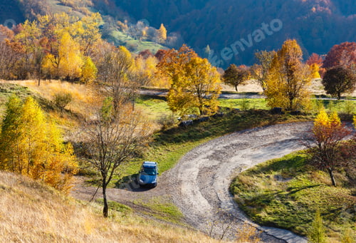 Preview: Unrecognizable Car On Dirty Secondary Road To Mountain Pass In Autumn Carpathian Mountains And