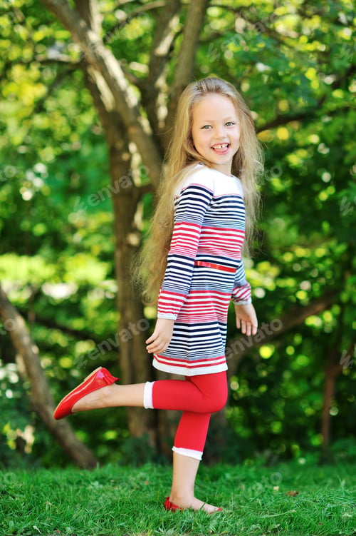 Preview: Sweet Little Girl Posing In A Green Park