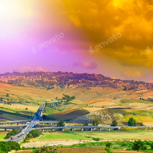 Preview: Landscape Of Sicilian Hills At Sunrise. Asphalt Road Elevated By Columns Due Of Frequent