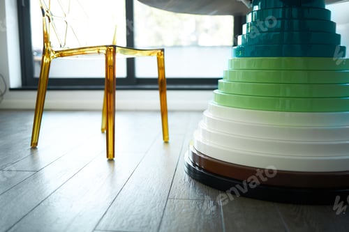Preview: Detail Of A Wooden Table Stand And A Clear Plastic Chair