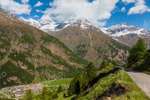 Preview: Summer Alps Mountain Landscape With Fir Forest On Slope And Snow Covered Rocky Tops In Far