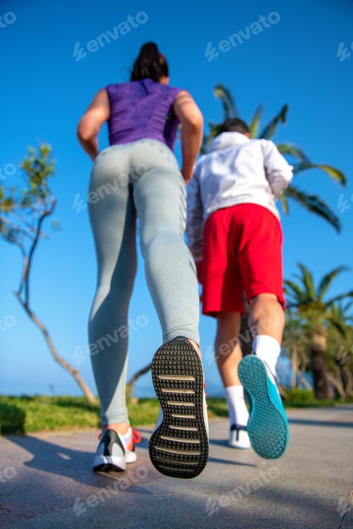 Preview: Running Couple Jogging On Beach. Runners Training Together. Man And Woman Joggers Exercising