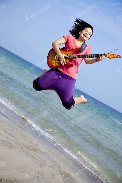 Preview: Young Brunet Girl With Guitar On The Beach.