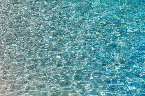 Preview: Blue Sea Flowing Water Surface With Waves And Some Pebbly Bottom View. Abstract Background Pattern.