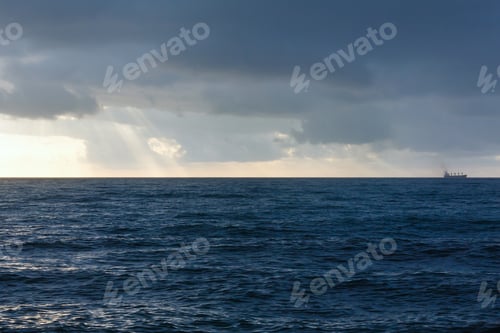 Preview: Seascape And Sunbeams Breaking Through Gray Clouds