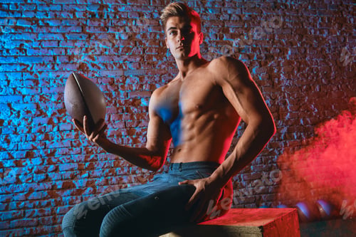 Preview: Handsome Caucasian Bodybuilder Posing With Medball In Dual Colores Brick Background. Beautiful