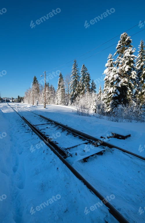 Preview: Railway Through Snowy Fir Forest And Remote Alpine Helmet In Carpathian Mountains, Snow Drifts On