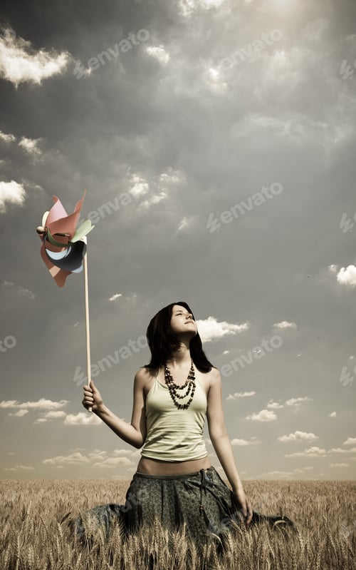 Preview: Girl With Wind Turbine At Wheat Field. Photo In Vintage Style