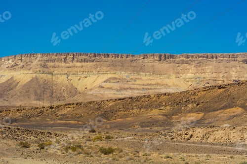 Preview: Electrical Power Lines On Pylons In The Landscape Of The Middle East. Rocky Hills Of The Negev