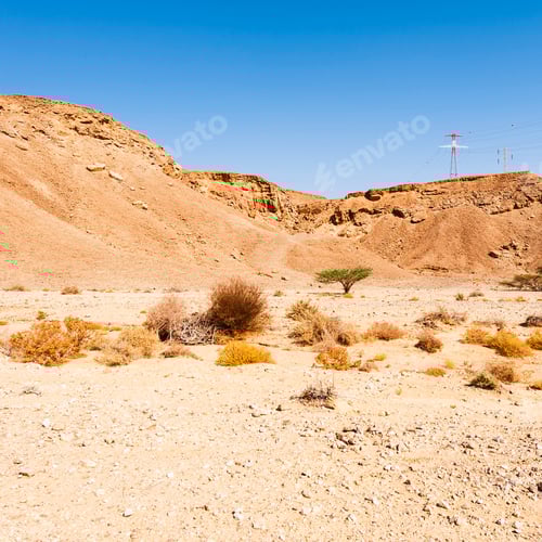 Preview: Electrical Power Lines On Pylons In The Landscape Of The Middle East. Rocky Hills Of The Negev