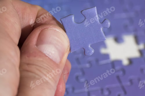 Preview: A Man Is Holding The Missing Piece Of A Puzzle. The Suitable Spot Is In The Background.