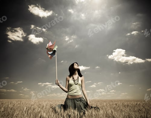 Preview: Girl With Wind Turbine At Wheat Field. Photo In Vintage Style
