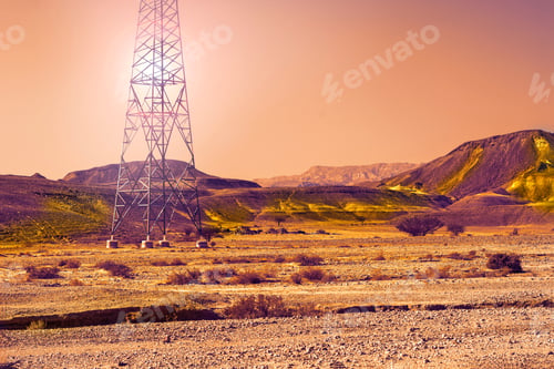 Preview: Electrical Power Lines On Pylons In The Landscape Of The Middle East At Sunset. Rocky Hills Of The