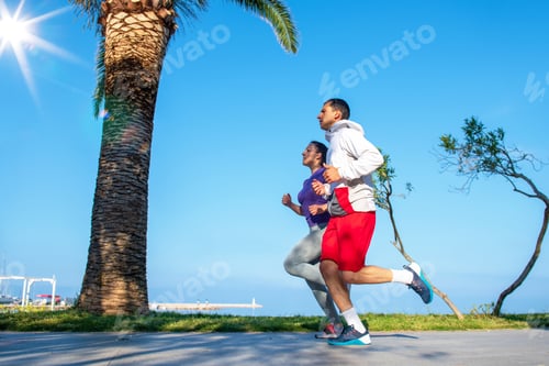 Preview: Running Couple Jogging On Beach. Runners Training Together. Man And Woman Joggers Exercising