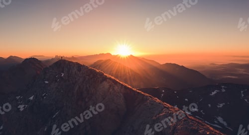 Preview: Male Hiker At The Top Of The Mountain At Sunrise. Beautiful Scenery In The Alps In The Morning.