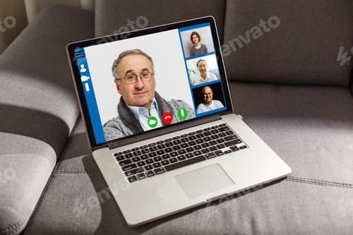 Preview: Close-Up Of Businessman Video Conferencing On Laptop At Desk In Office