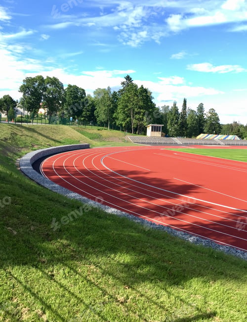 Preview: Sports Field On A Sunny Summer Day. Running Tracks And Green Football Field.