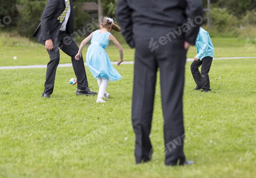 Preview: Grandfathers Are Playing Football Outdoors With Their Grandchildren. Children Are Enjoying The Life.