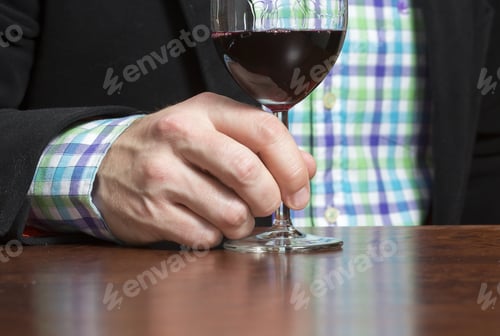 Preview: A Glass Of Red Wine. A Business Man Is Holding A Wine Glass In His Hand. The Man Is Wearing Jacket