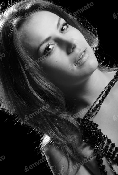 Preview: Portrait Of A Beautiful Brunette On Black Background