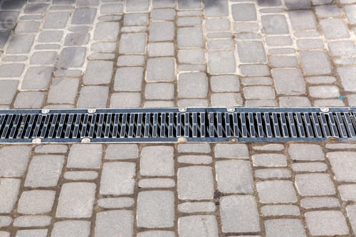 Preview: A Lattice Of A Drainage Paving System On A Path Made Of Square Stone Tiles, Close Up.