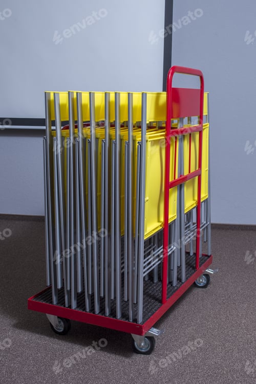 Preview: Stacked Folding Chairs On A Trolley For Transport And Storage