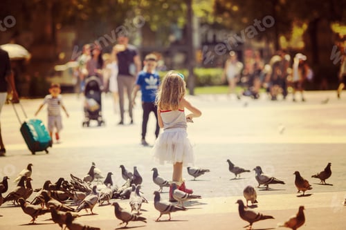 Preview: A Girl Feeding Pigeons In The Mall. Image Has A Strong Vintage Effect.