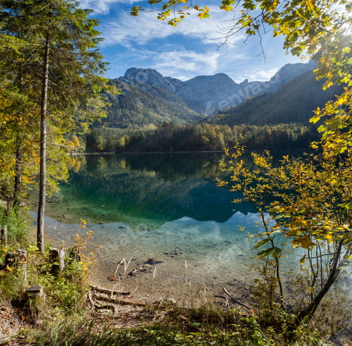 Preview: Sunny Idyllic Colorful Autumn Alpine View. Peaceful Mountain Lake With Clear Transparent Water And