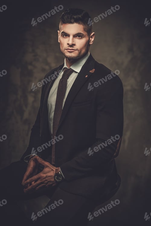 Preview: Serious Well-Dressed Hispanic Man Posing On Dark Background.