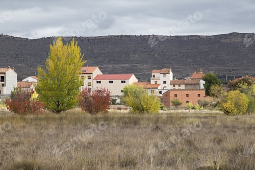 Preview: Autumn Landscape With Yellow Leaves Gudar Mountains Teruel Aragon Spain. Mora De Rubielos Village.